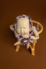 newborn baby mannequin doll. doll in a hat, mannequin for training photographers
