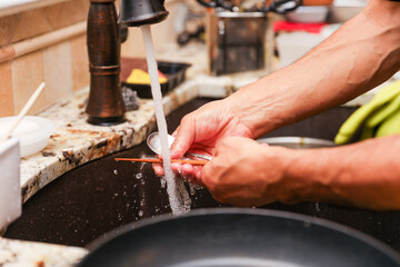 hand-washing dishes, symbolizing equality and shared responsibilities of men and women gender roles...