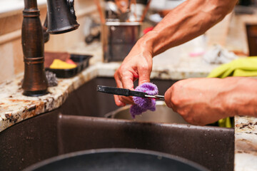hand-washing dishes, symbolizing equality and shared responsibilities of men and women gender roles...