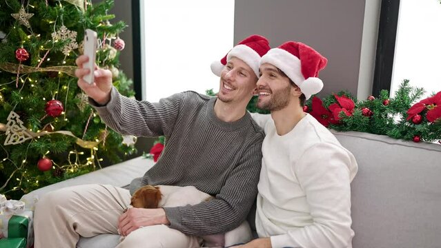 Two men couple celebrating christmas make selfie by smartphone at home