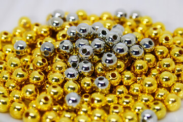 Silver beads on golden beads to make necklaces and bracelets