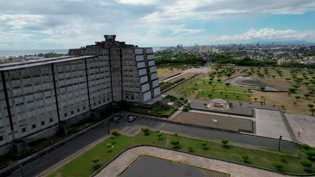 Aerial cinematic footage of the beautiful Columbus Lighthouse monument and the flag of Dominican Republic in Santo Domingo