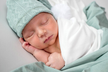 Close up of cute newborn baby sleeping on white background covered.Care,love,happiness concept.