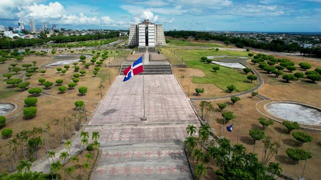 Aerial cinematic footage of the beautiful Columbus Lighthouse monument and the flag of Dominican Republic in Santo Domingo