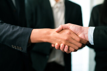 Asian business people shake hand after made successful agreement deal in meeting room, professional hand shaking with applause in corporate company. Quaint