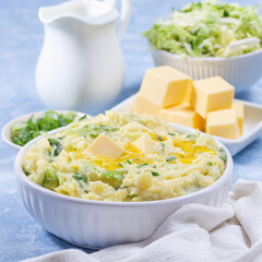 Delicious homemade Irish dish Colcannon or mashed potato with green cabbage and butter, square