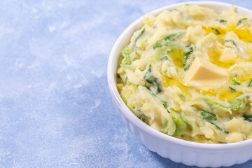 Delicious homemade Irish dish Colcannon or mashed potato with green cabbage, horizontal, copy space