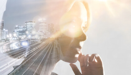 Double exposure of woman and business offices in urban setting