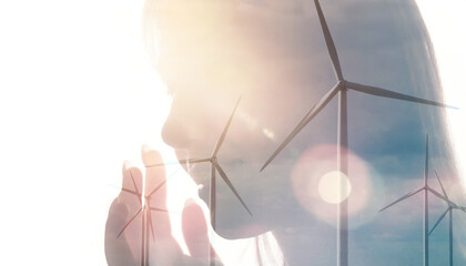 Double exposure of woman and wind farm turbines
