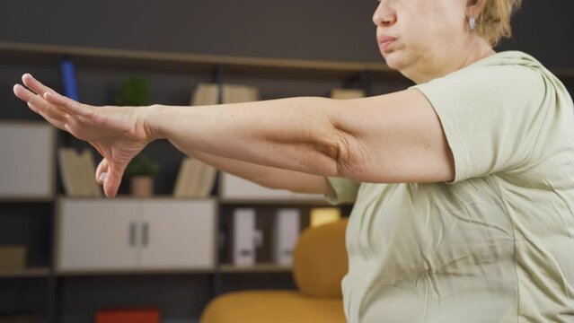 Woman having difficulty moving her arms.