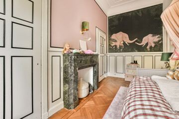 a bedroom with pink walls, white furniture and an art piece on the wall next to the bed is a marble fireplace