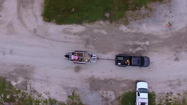 Aerial Top Panning Shot Of Pickup Truck Pulling Boat On Road - Bayou, Louisiana