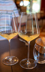 Tasting of Bordeaux white wine in Sauternes, left bank of Gironde Estuary, France. Glasses of white sweet French wine.