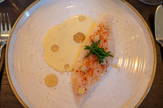 White fillet of most delicious fish John Dory, St Pierre or Peter's fish served with shell fish sauce in luxe restaurant in Bordeaux region, France