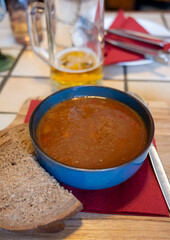 German food, thick, rich goulash meat soup served hot in bowl in old German cafe in countryside