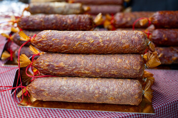 French food, artisan smoked meat sausages from pork on weekly marken in Belgian Durbuy small town
