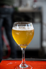 Famous fresh brewed beer served outside in Belgian beer festival in Durbuy,  special Belgian beer glass in sun lights