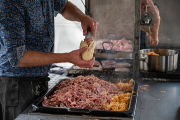 Street food in Belgium, grilled burgers, pork meat, white cabbage, making burgers with buns or pitas