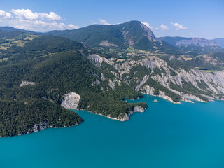 Aerial view on blue Lake of Serre-Poncon, reservoir border between Hautes-Alpes and Alpes-de-Haute Provence   departments, one of largest in Western Europe - obrazy, fototapety, plakaty