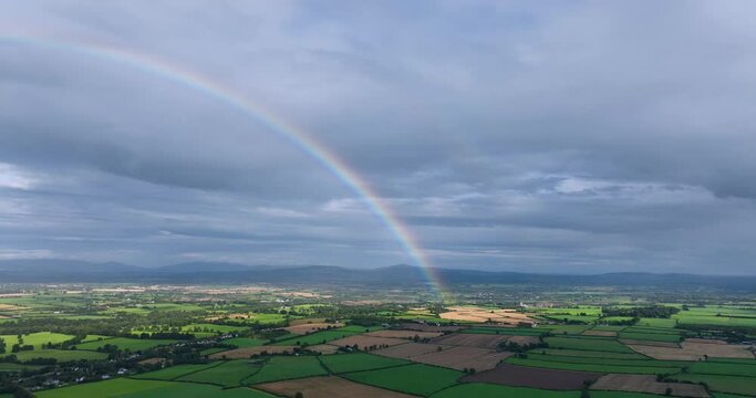 Big rainbow against the green fields of Ireland 4k