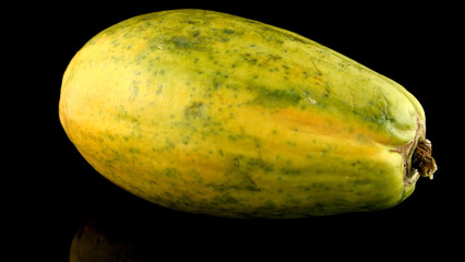 Papaya fruit on black background