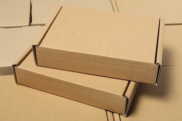 Many cardboard boxes as background, closeup. Packaging goods