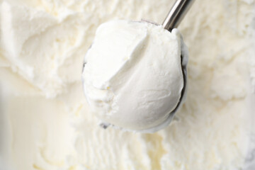 Steel scoop with tasty vanilla ice cream, top view