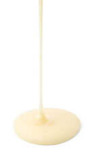 Pouring tasty condensed milk isolated on white