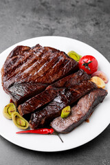 Delicious grilled beef meat on grey table, closeup