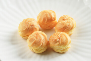 Close Up Profiteroles with Whipped Cream and Chocolate Filling.