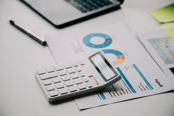 Businesswoman or accountant working Financial investment on calculator, calculate, analyze business and marketing growth on financial document data graph, Accounting, Economic, commercial concept.