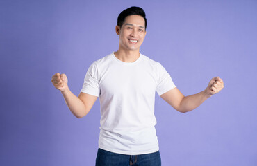 Image of Asian man posing on purple background