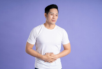 Image of Asian man posing on purple background