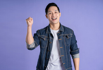 Image of Asian man posing on purple background