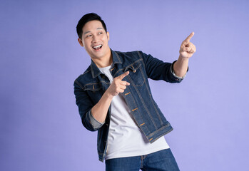 Image of Asian man posing on purple background