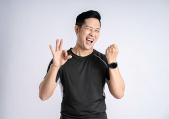 Fototapeta premium Portrait of a man wearing sports clothes posing on a white background