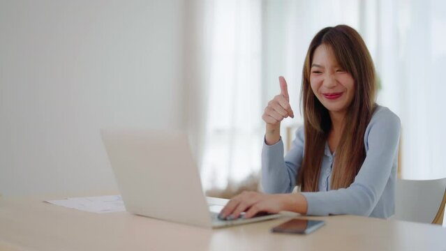 Young asian woman working on computer laptop at house. Work at home, Video conference, Video call, Student learning online class, meeting conference