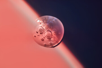 Pipette with serum for the face on the border of light and shadow.