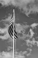 American Flag on a Flagpole in a Breeze with a Sky Background.