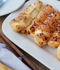 Delicious baked cheese rolls, baked crunchy cheese bread on an catering event, selected focus, cheese wrapped in bread and baked
