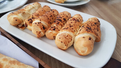 Delicious baked cheese rolls, baked crunchy cheese bread on an catering event, selected focus, cheese wrapped in bread and baked