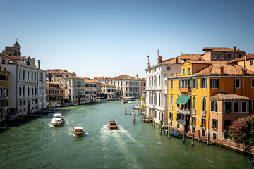 Scenic canal with old buildings in Venice, Italy. Boats as the mean of the transportation