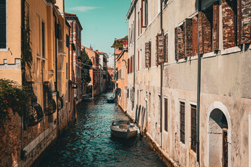 Fototapeta na wymiar Scenic canal with bridge and old buildings with potted plants in Venice, Italy