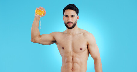 Orange, splash and portrait of man in studio for vitamin C, natural cosmetics or healthy diet on...