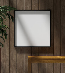 a square frame mockup poster hanging on the wooden wall with plant and wooden table