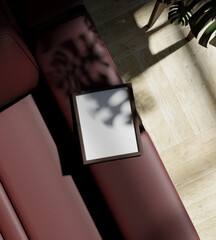 a mini frame mockup poster laying on the red sofa from top view