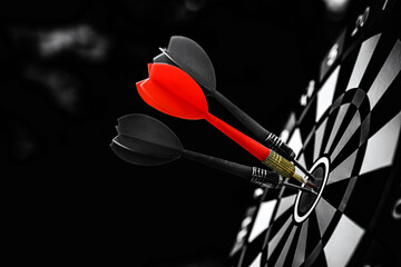 Bullseye or Bulls eye target or dartboard has red dart arrow throw hitting the center of a shooting...