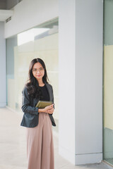 Beautiful Asian businesswoman crossed arms looking at the camera.