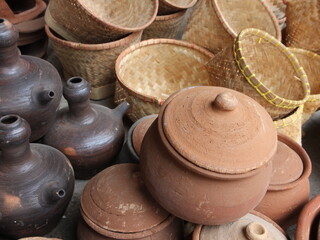 photo of pottery, jugs and woven bamboo containers in a traditional pottery shop in Indonesia