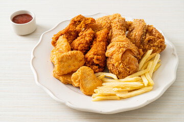 fried chicken with french fries and nuggets on plate